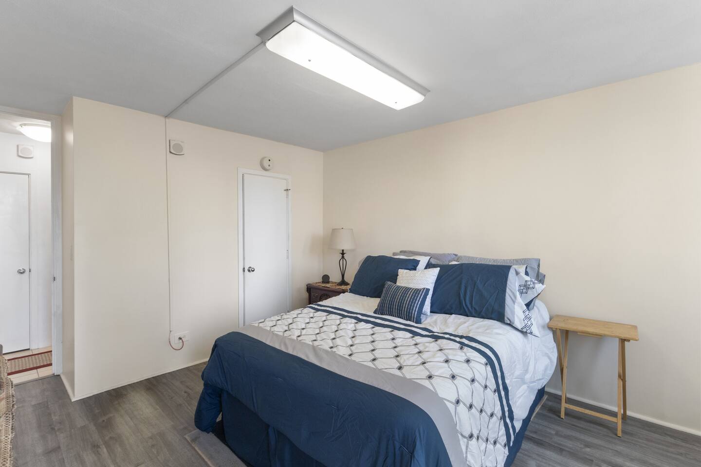 The bedroom features a generously sized walk-in closet (not pictured) including plenty of hangers, a shoe rack, hamper, and luggage rack for your convenience.