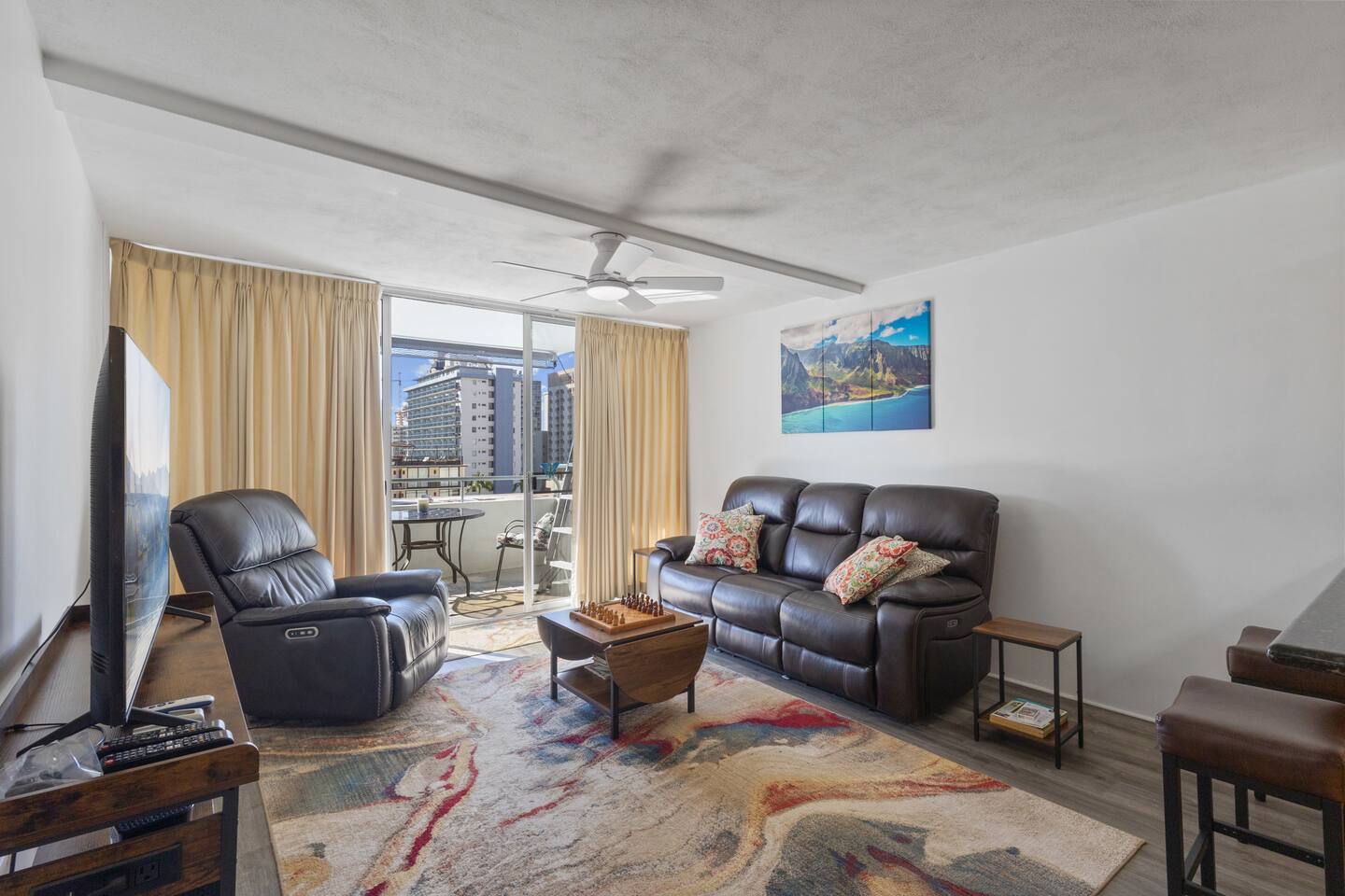 Relax in the spacious living room featuring plush reclining seating.