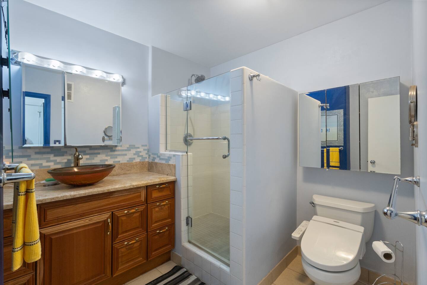 Clean, well-lit bathroom featuring a spacious walk-in shower and ample counter space for a comfortable stay
