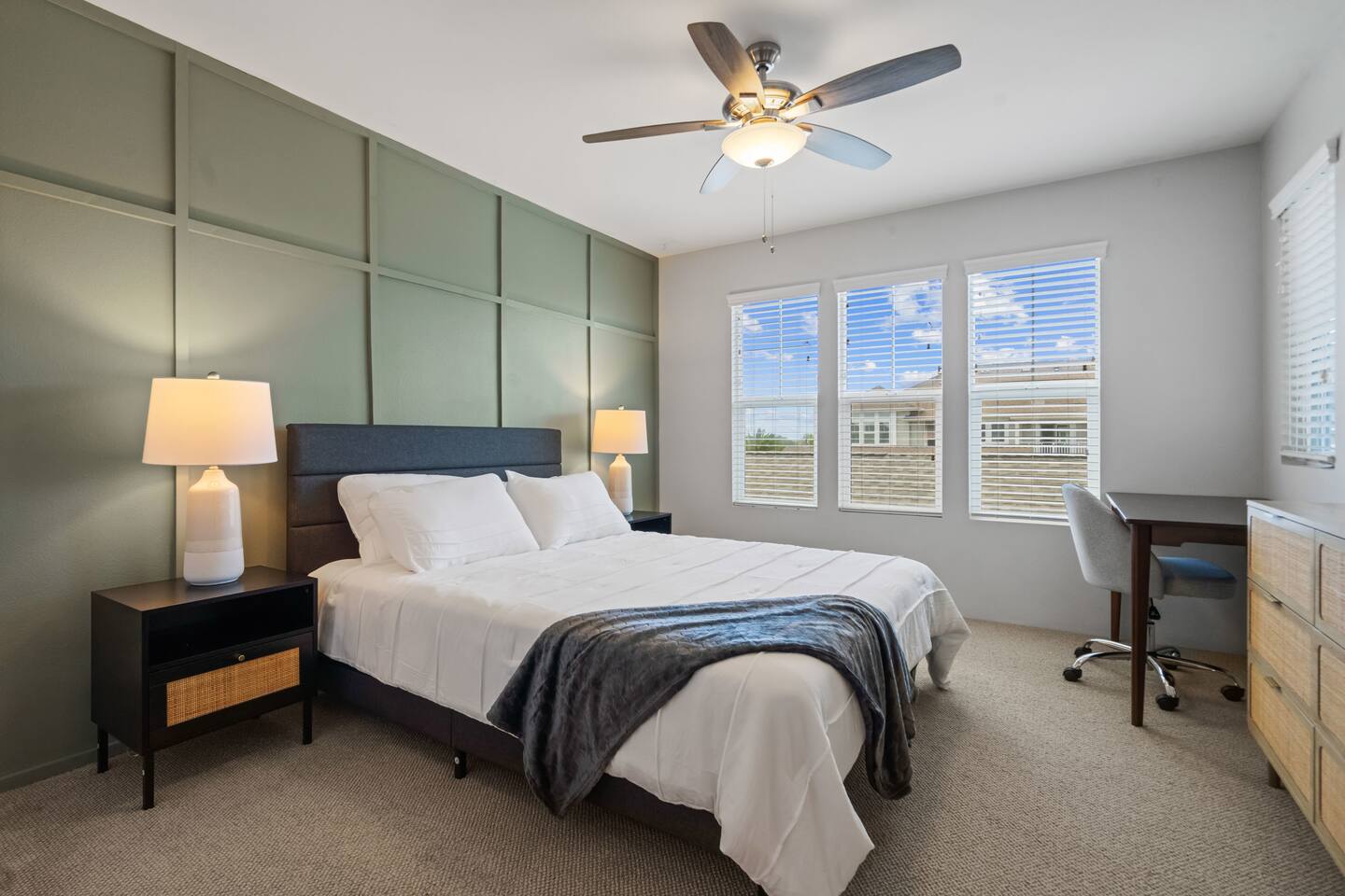 Beautifully curated master bedroom featuring a plush queen bed, stylish accent wall, and plenty of natural light for a serene retreat.