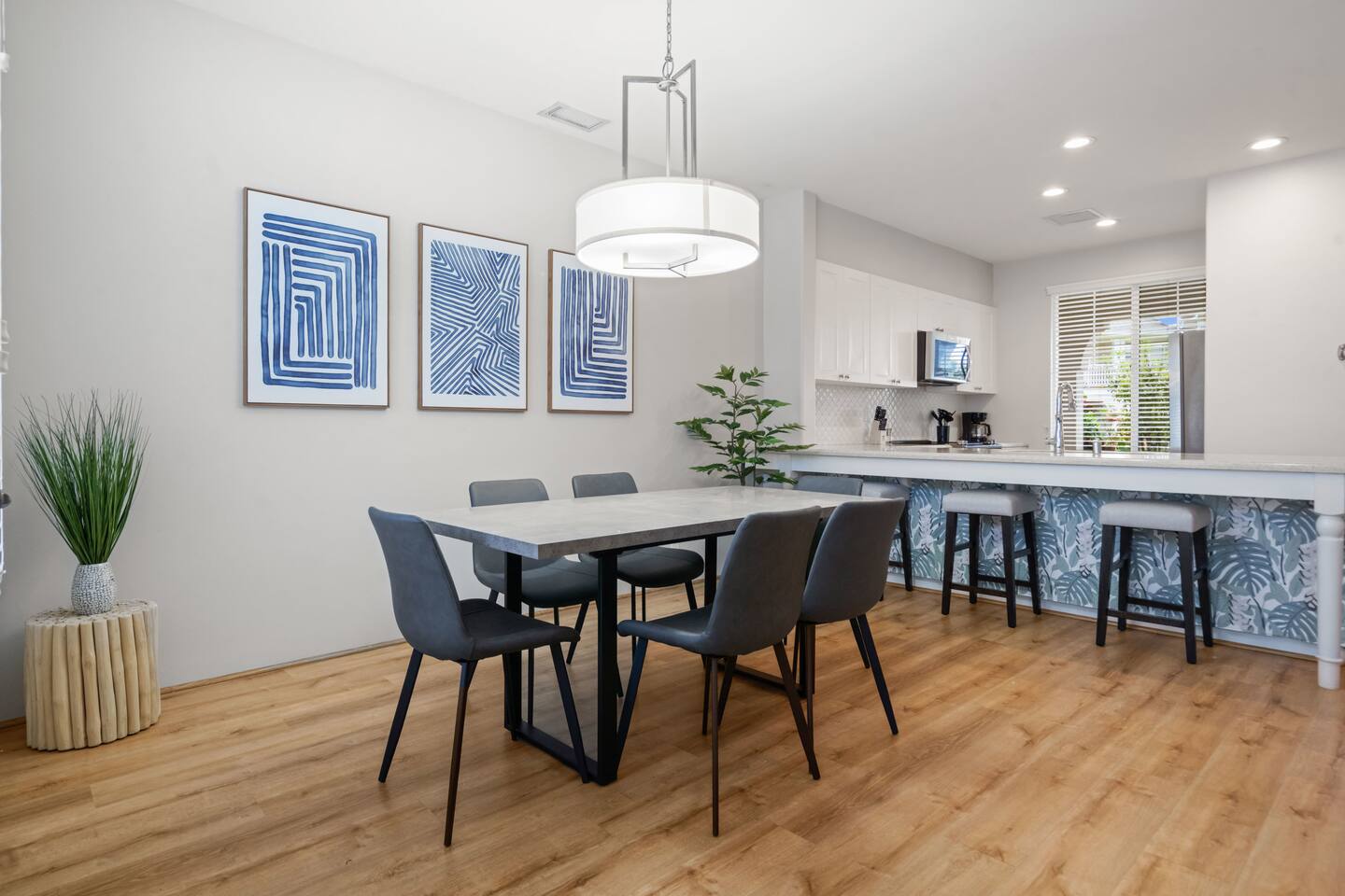 Stylish dining area with modern décor and seating for six-perfect for shared meals and gathering with friends or family.