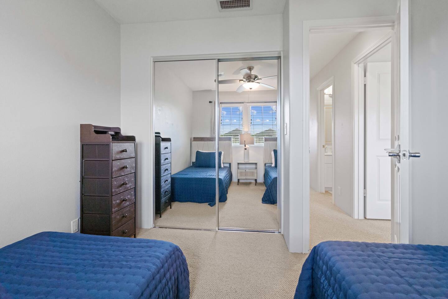 The twin bedroom offers generous closet space and additional storage drawers-perfect for keeping belongings organized during your stay.