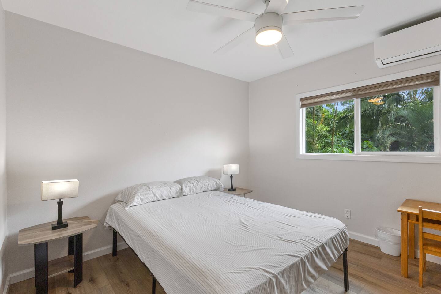 Bright and simple bedroom with lush island views-part of a spacious home with room for everyone to relax and unwind.