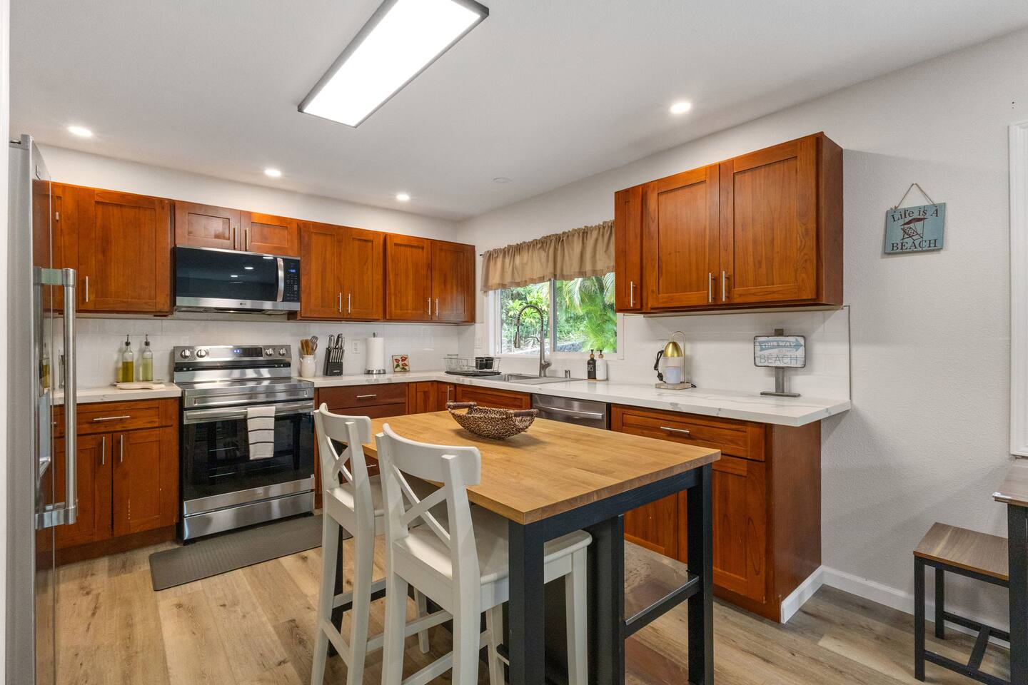 Bright, modern kitchen with warm wood cabinetry and a cozy island-perfect for cooking and gathering.