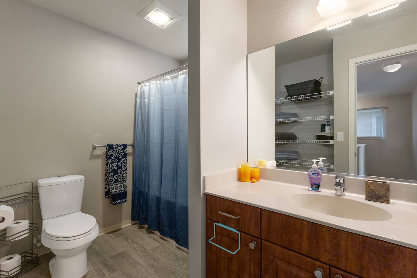 This spacious full bathroom is perfect for everyone - full tub and shower combo, roomy vanity, and built in shelves for storage.