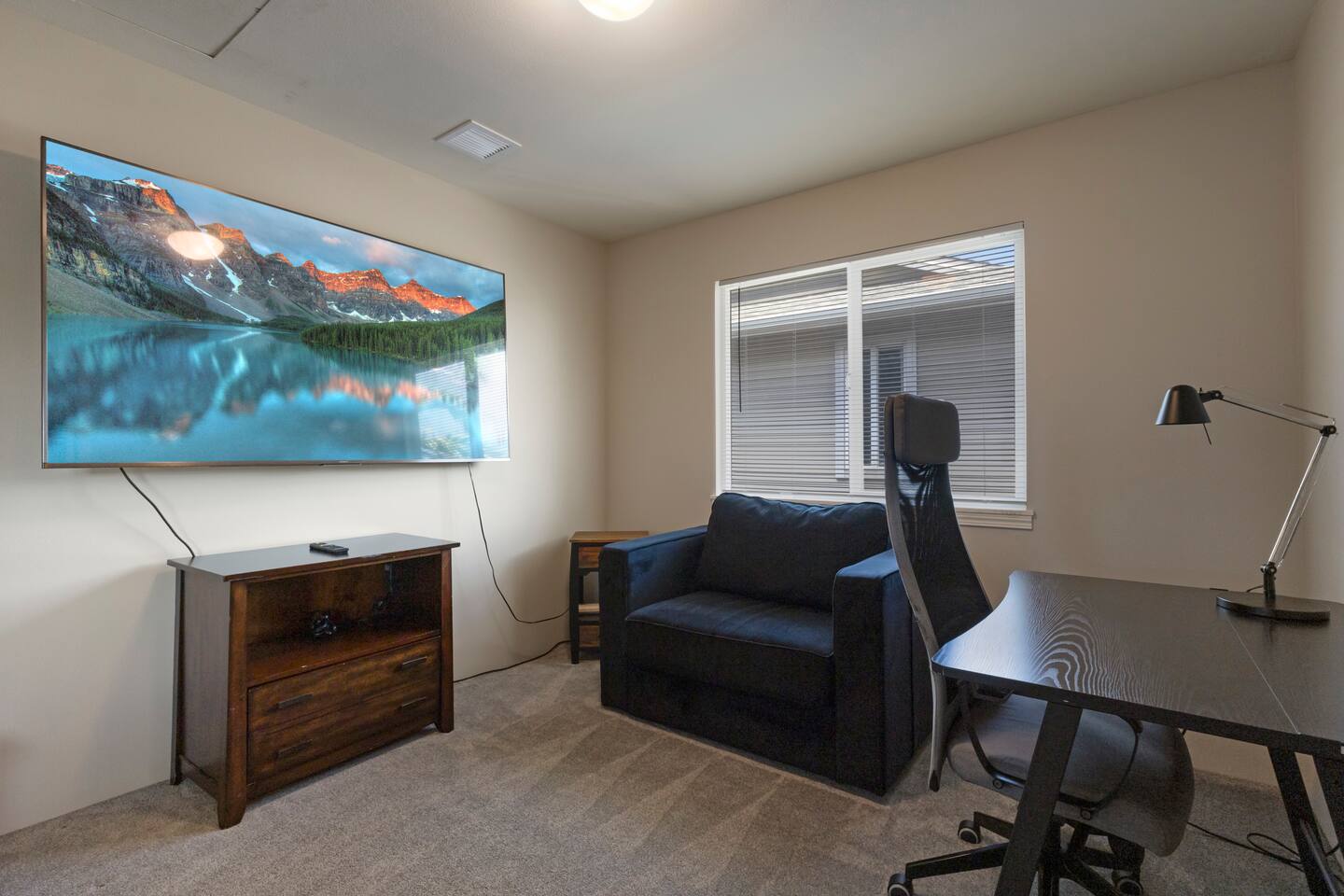 A den inside the master bedroom features a dedicated work space and lounge area.