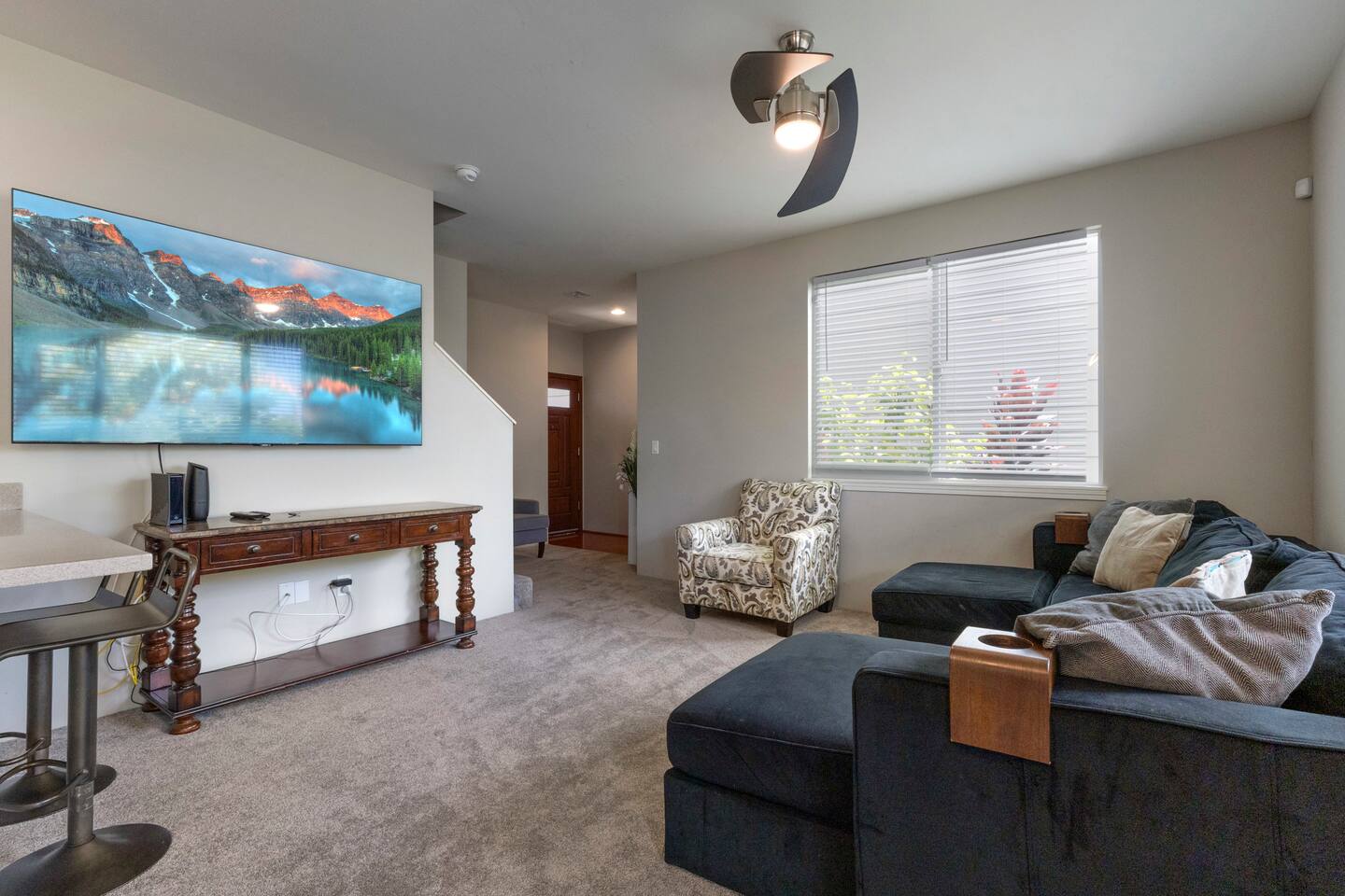 Inviting living room with plenty of natural light-perfect for relaxing with a movie on the 75 inch TV.