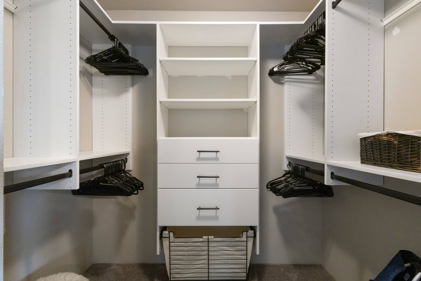 Spacious walk-in closet with built-in shelving and ample hanging space-perfect for staying organized throughout your stay.