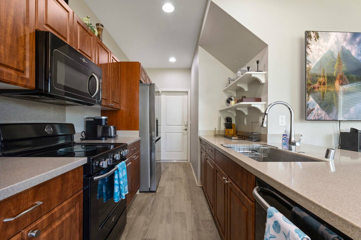 Well-appointed kitchen featuring abundant cabinet space and convenient appliances, including a Nespresso machine and blender-ideal for everyday convenience.