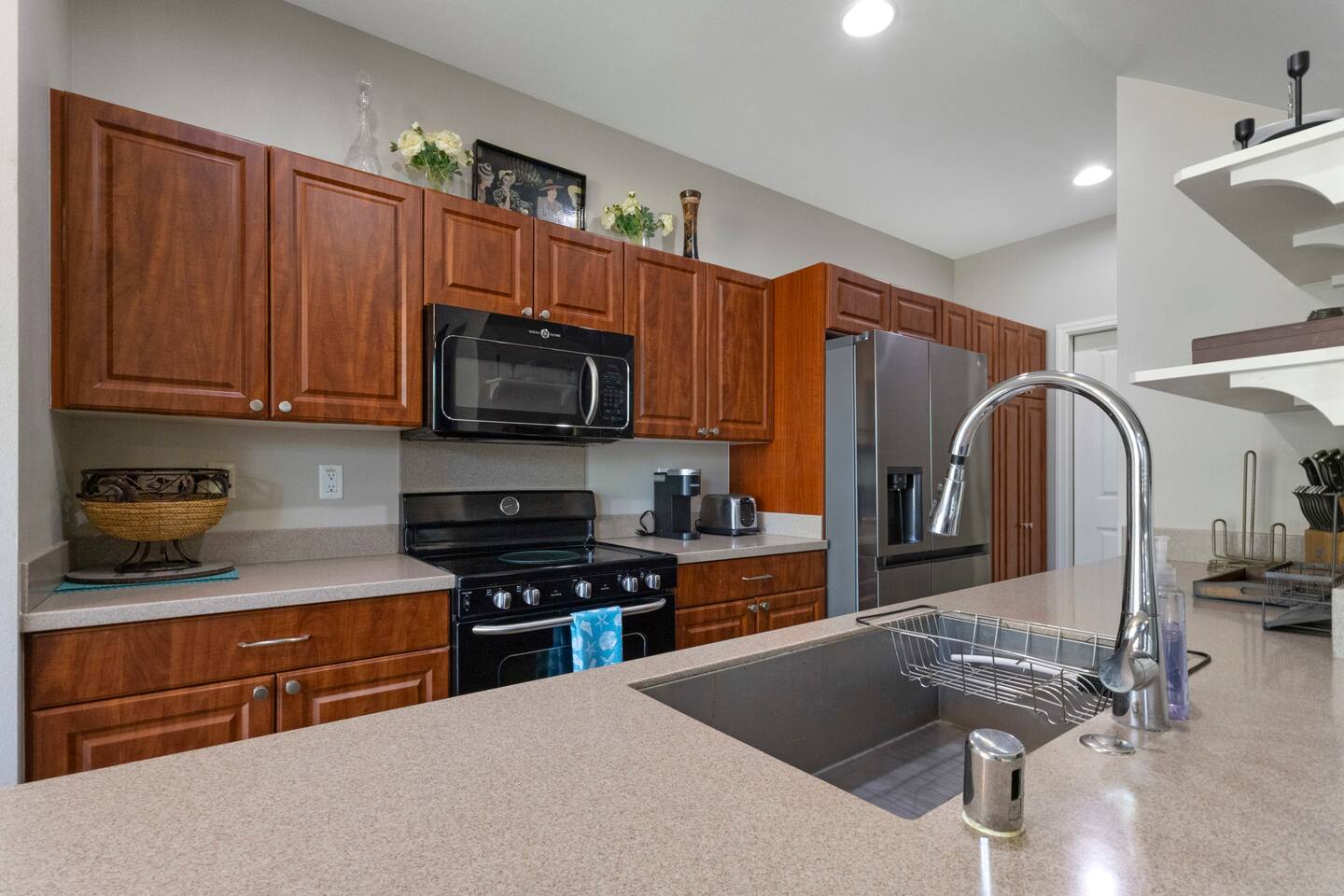Spacious, well-equipped kitchen featuring modern appliances, ample counter space, and warm wood cabinetry-perfect for cooking and gathering.