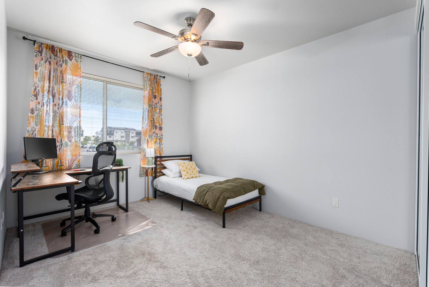A cozy corner for rest or remote work, this bright bedroom has got you covered.