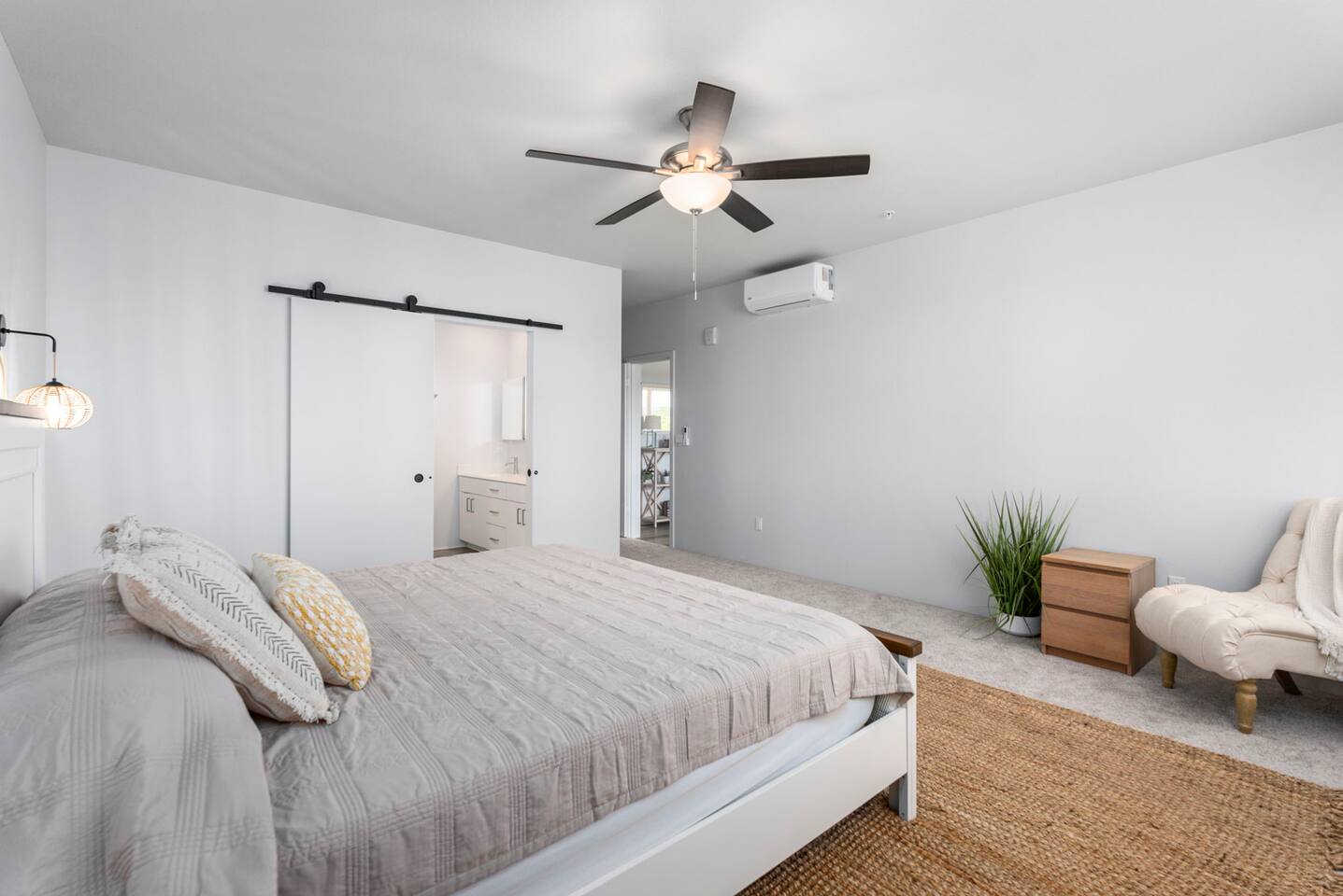Bright and welcoming second queen bedroom featuring calming coastal décor.