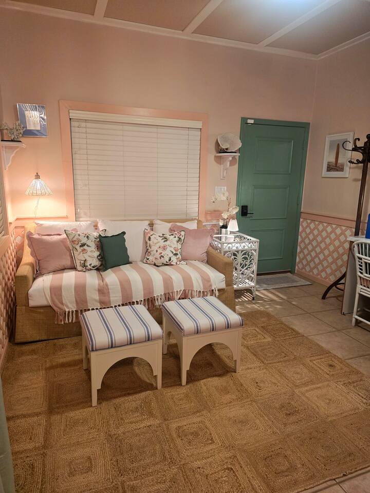 From floral pillows to sunlit details, this space is a warm embrace waiting to welcome you home.