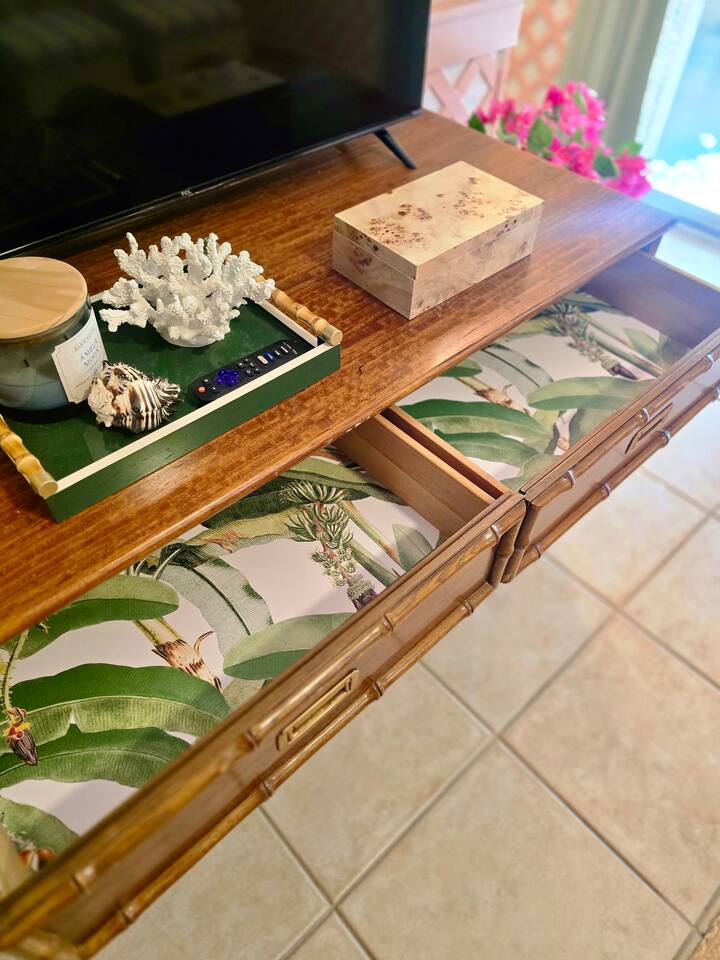 A curated corner with tropical flair, perfect for unwinding with your favorite show.