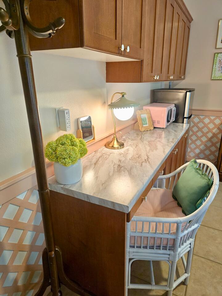 From the pink microwave to the floral touches, this kitchenette is as delightful as it is efficient