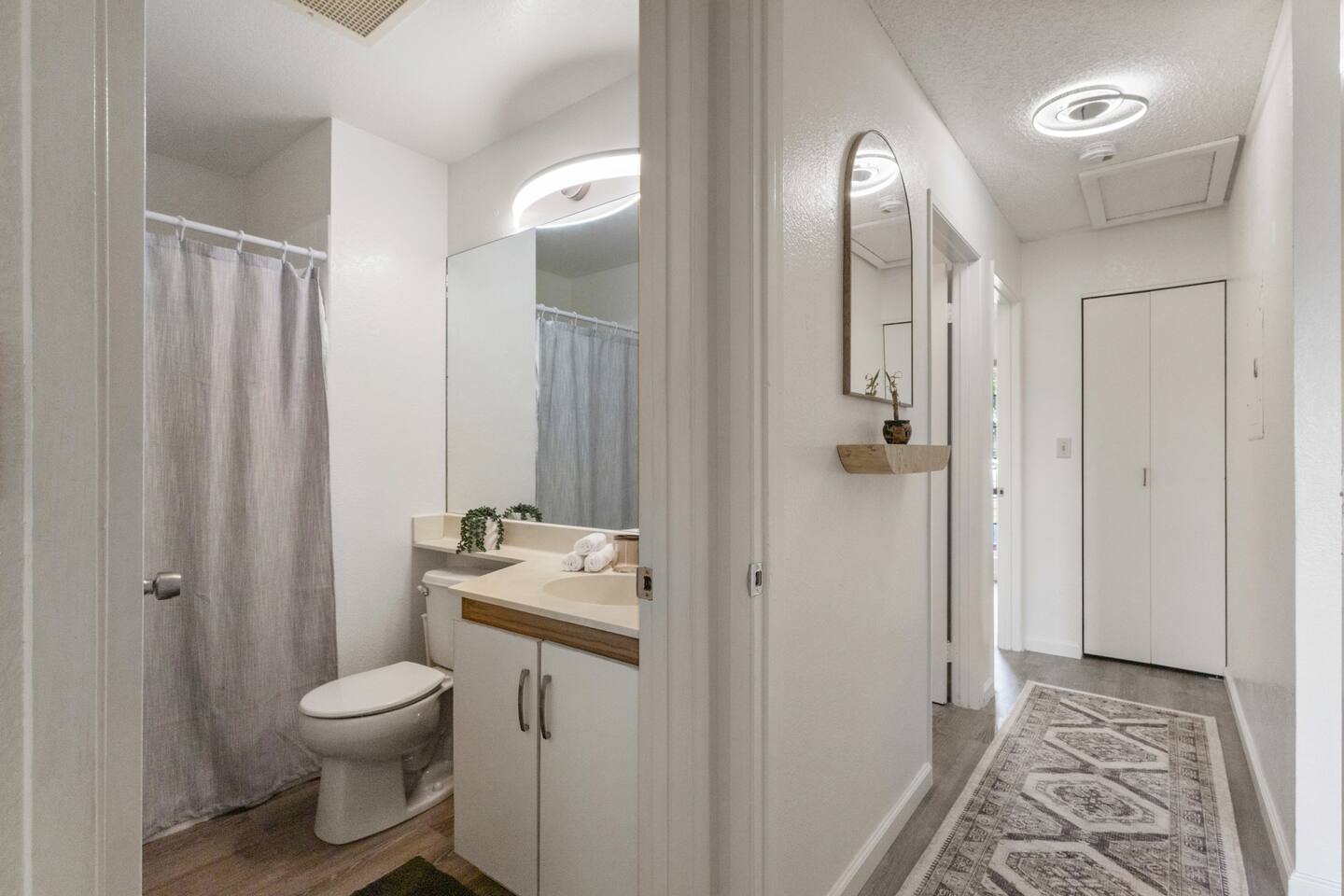 Step into a spotless bathroom with modern finishes and cozy accents.