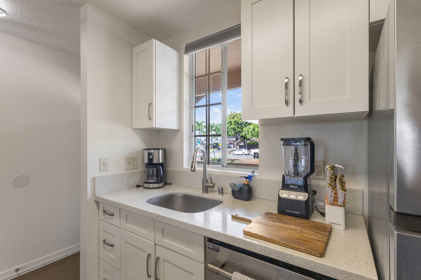 Start your day with fresh coffee, natural light, and a peaceful peek outside. This kitchen corner is as functional as it is inviting.