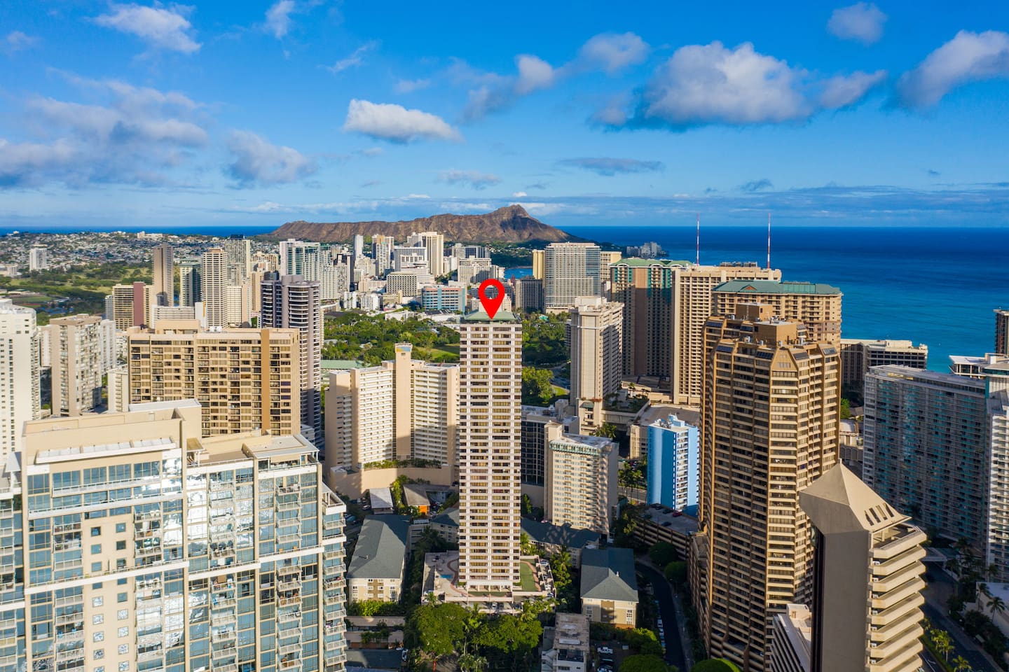 Ocean glint, urban grid, and a landmark in sight. This is Honolulu, pinpointed and picturesque. Your place in paradise.
