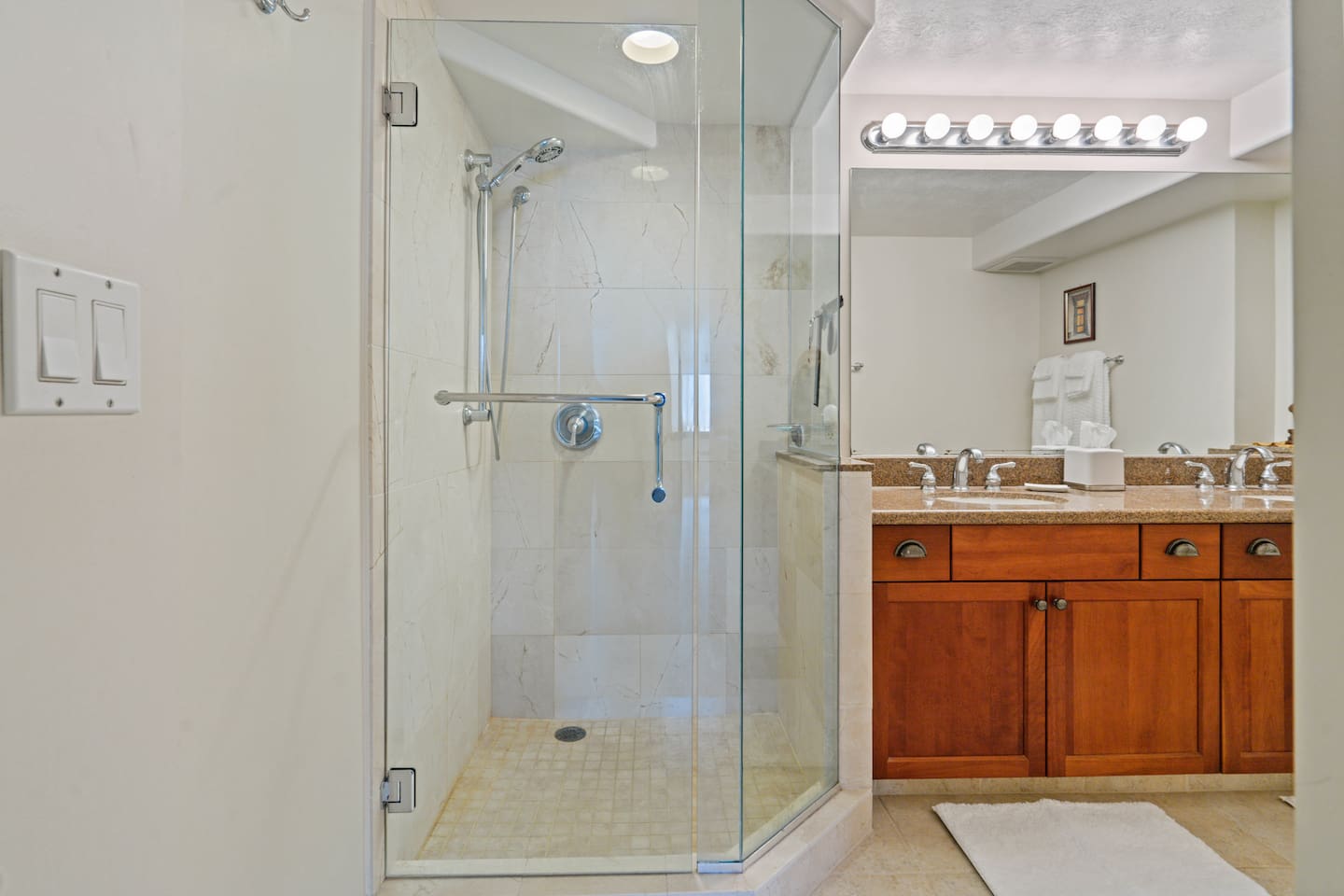 Double sinks, glass shower, and spa-like calm. Bright lights, clean lines, and island ease. Your refresh zone awaits.