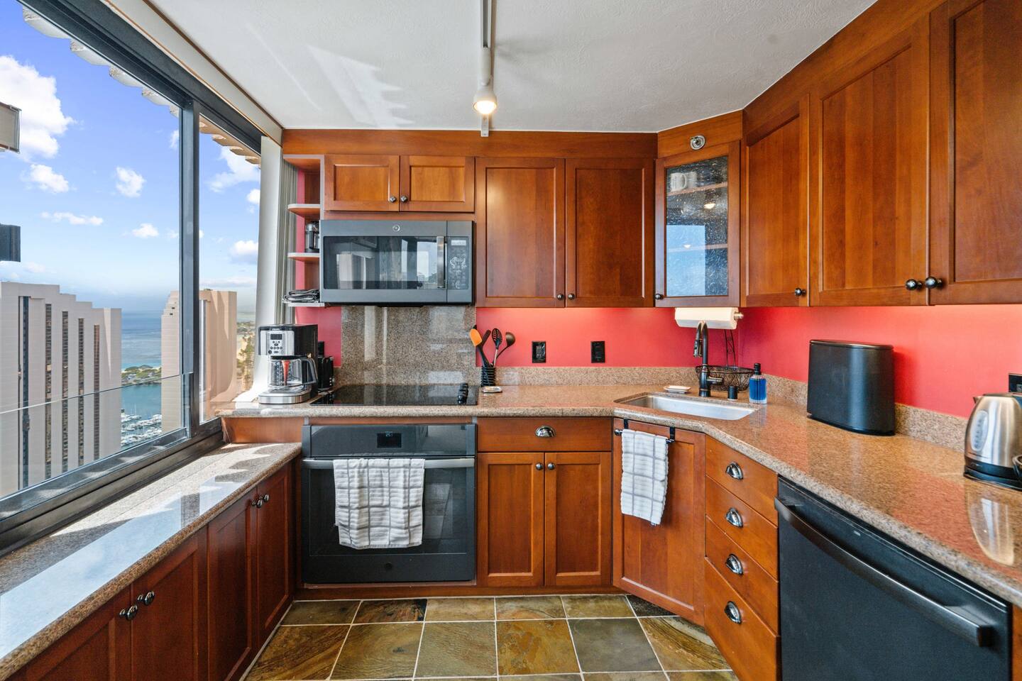 Morning coffee with a view like this? Ocean breeze, city sparkle, and granite calm. Your kitchen, your island rhythm.