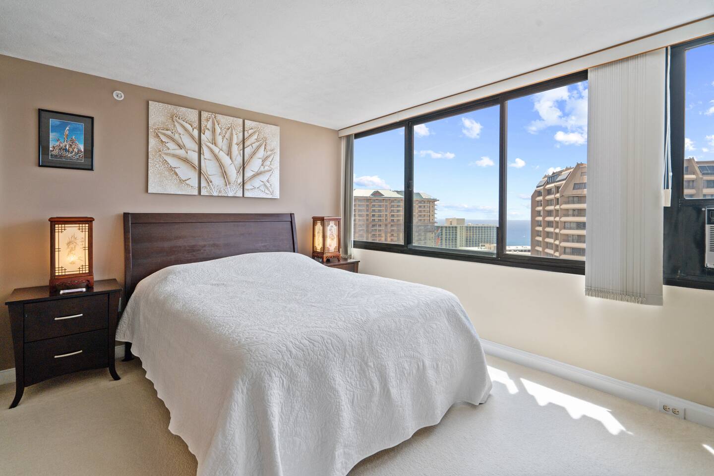 Framed leaves, soft light, and sea views beyond. Your peaceful perch in the heart of Honolulu. Rest easy, rise inspired.