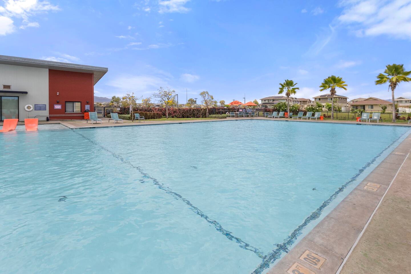 Clear skies, palm trees, and a sparkling pool ,this outdoor space is made for sunny-day lounging.