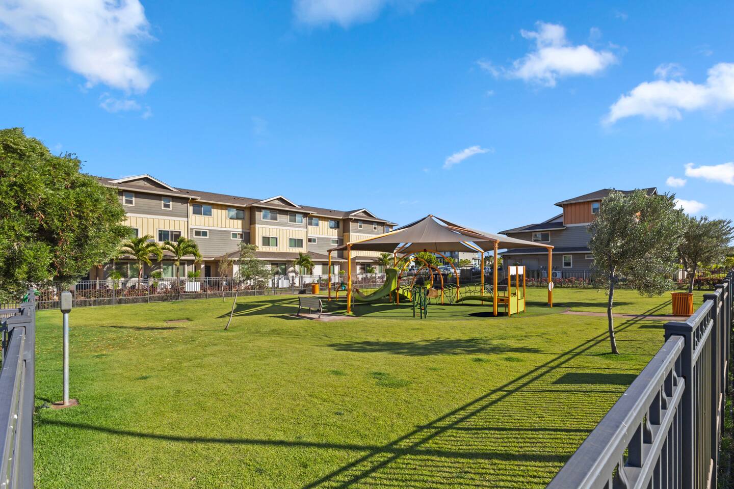 Slides, shade, and soft turf , this secure play zone is perfect for sunny afternoons and family fun.