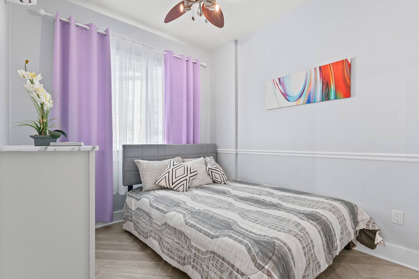 This serene bedroom blends soft textures, gentle colors, and natural light to create a calm space to recharge after a day out.