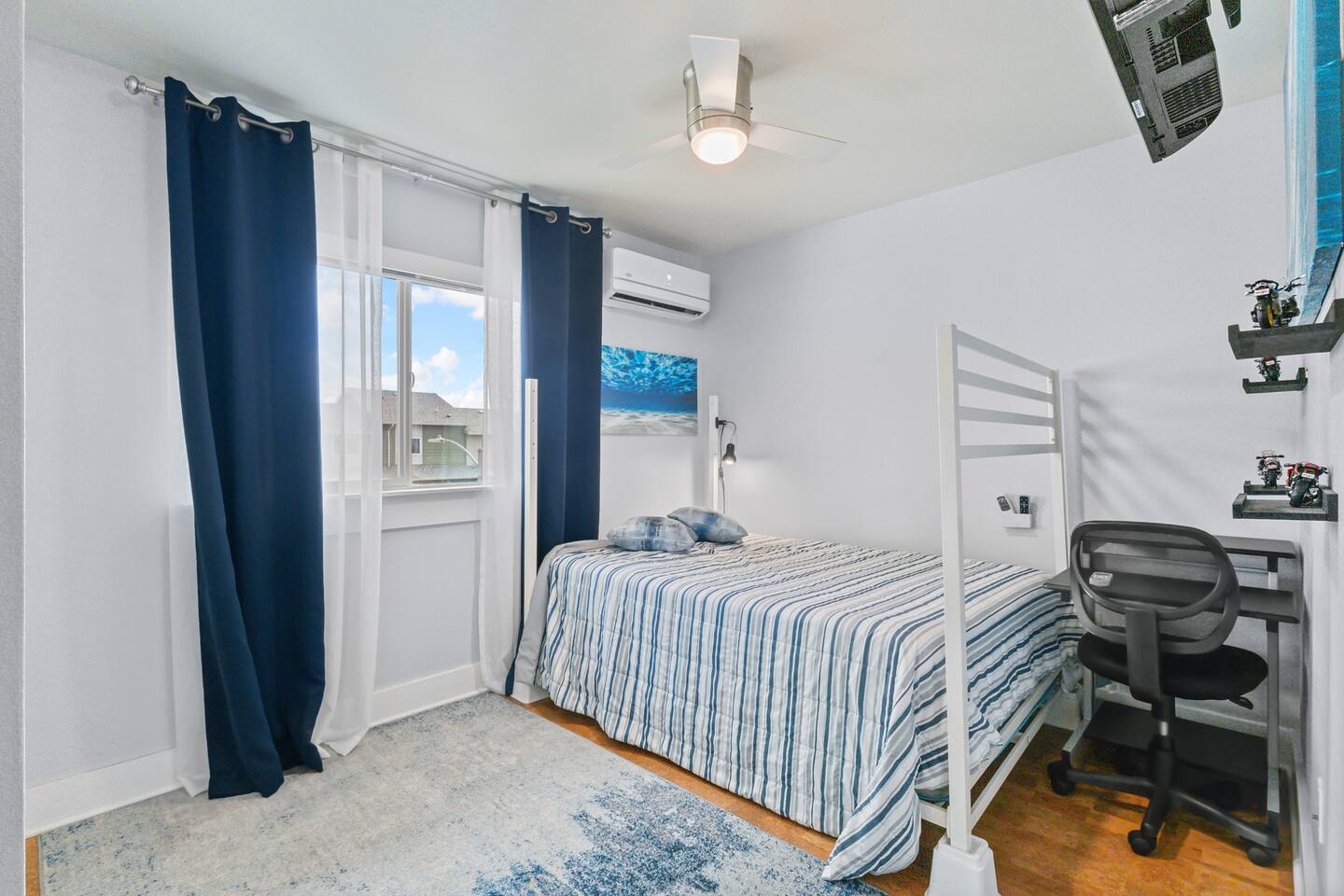Blue tones, soft textures, and playful decor make this room feel both cozy and practical.