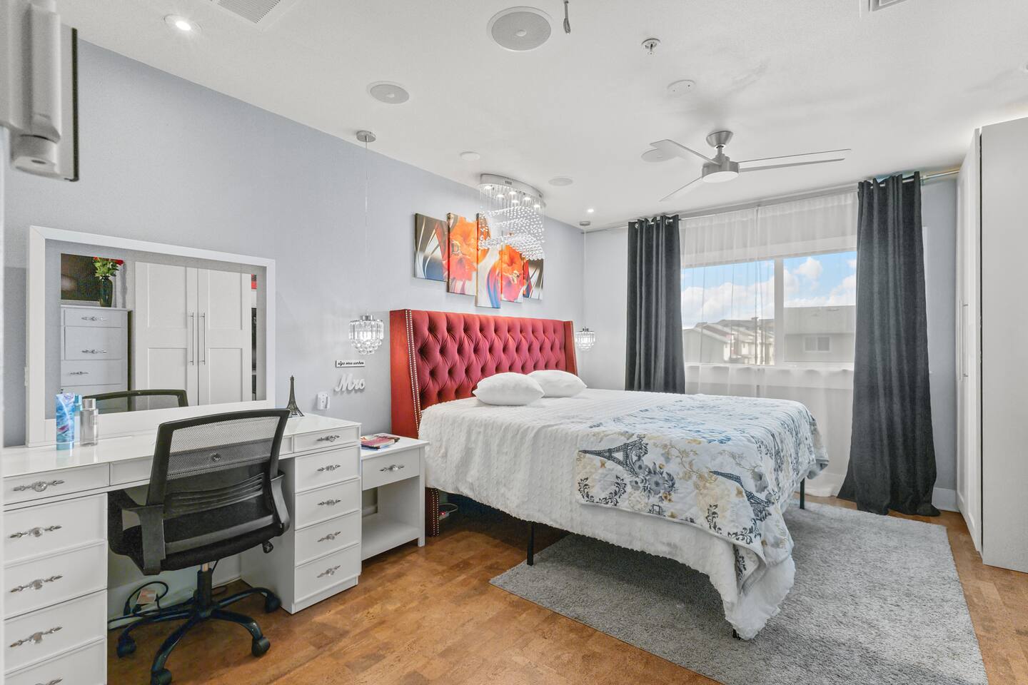 Crystal sconces, abstract art, and a chandelier overhead bring a touch of luxury to this stylish retreat.