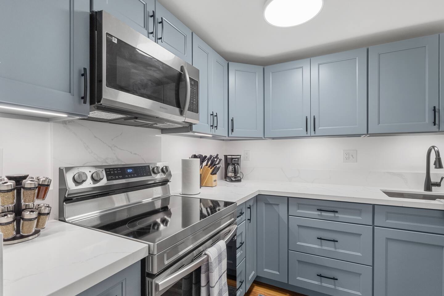 Your bright corner for morning brews, with marble shine, soft blue cabinets, and everything within reach