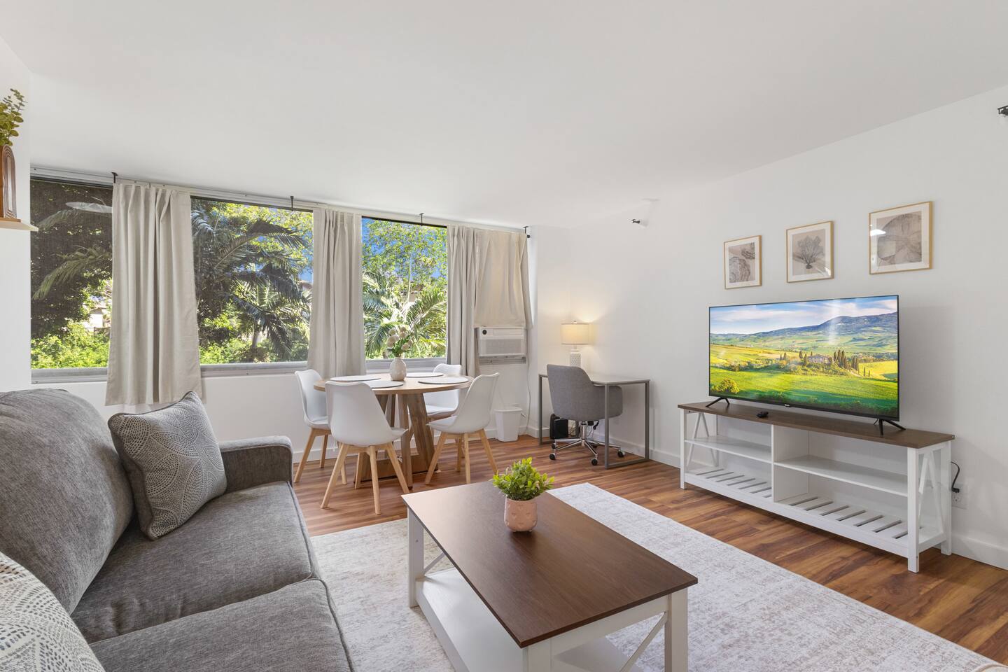 Your stylish corner for coffee and conversation, wrapped in warm wood, breezy curtains, and a touch of floral charm.
