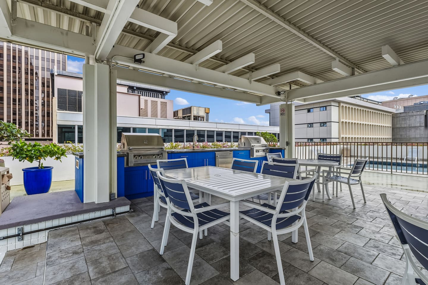 Your open-air dining spot, with stainless steel grills, shaded tables, and city views all around.