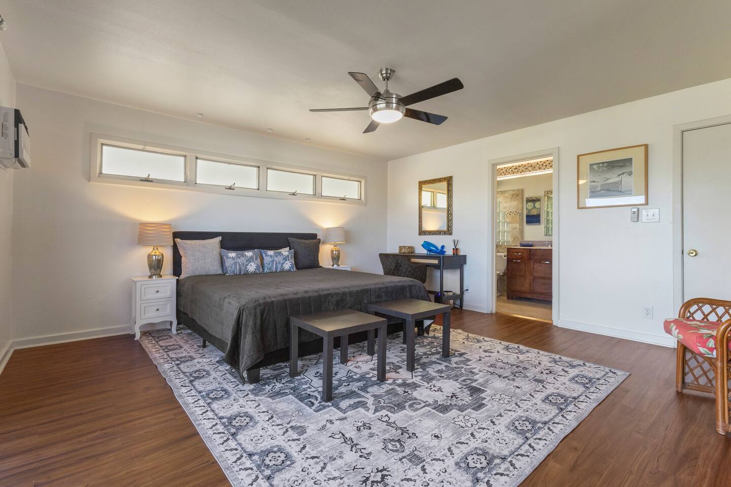 Primary Suite on the lower level with a work space, a huge California King sized bed and ample space to spread out.