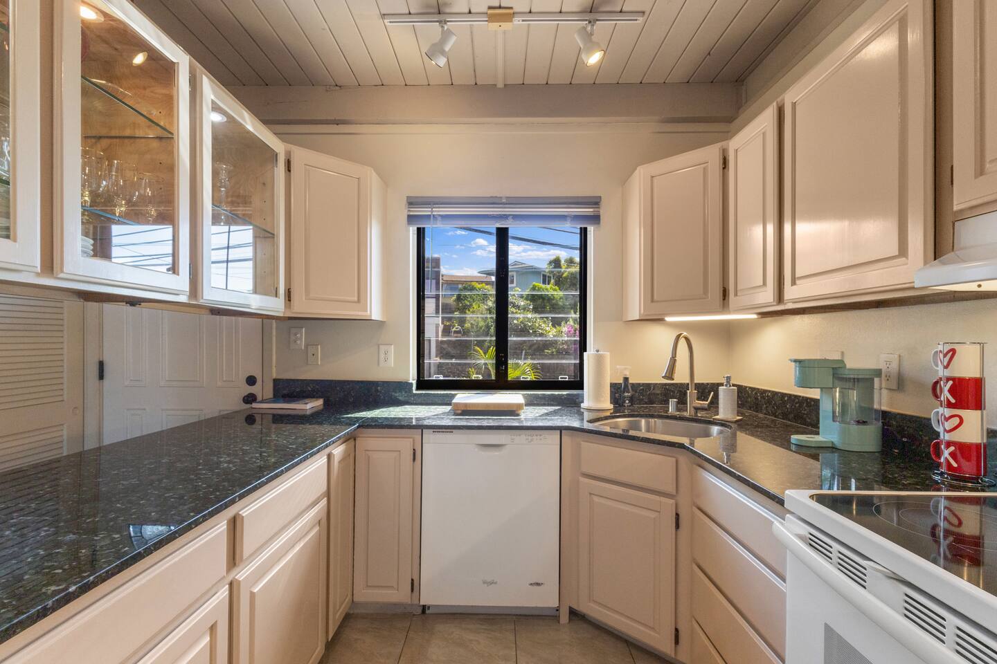 Fully equipped kitchen for prepping meals for the group, with a passthrough for serving up Hawaiian pupu's to-go with a glass of wine to head straight to the deck for catching the sunset.