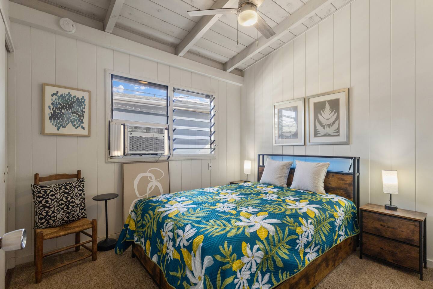Bedroom three with a reading chair and Post-Modern and Hawaiiana decor and AC