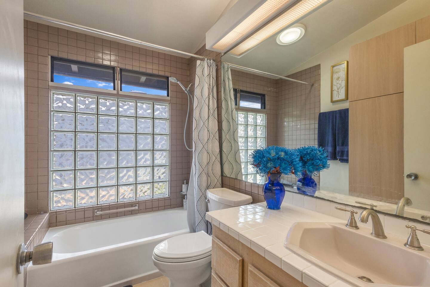 Vintage soul, modern comfort. Soak away the day in this light-filled bathroom where classic glass-block textures meet the quiet luxury of an architectural icon.
