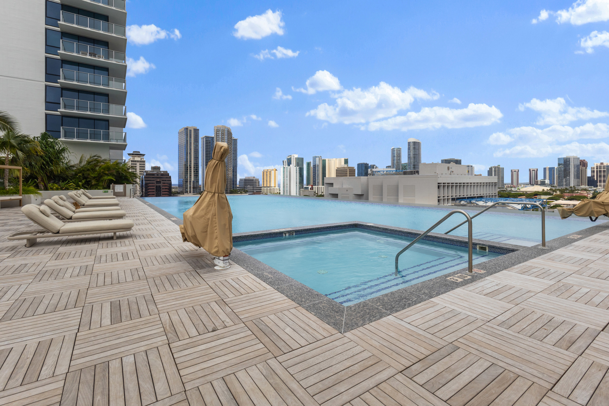 Rooftop infinity pool and hot tub with stunning city skyline views