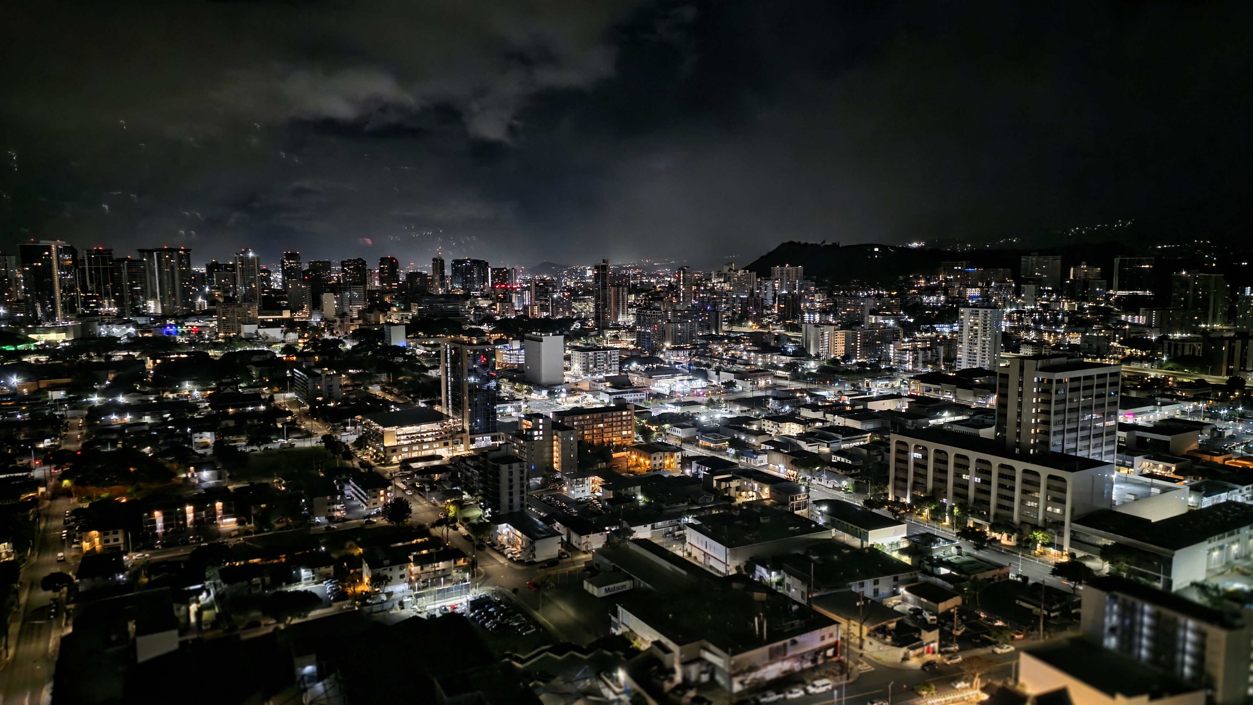 Sweeping city skyline views with dazzling lights after dark