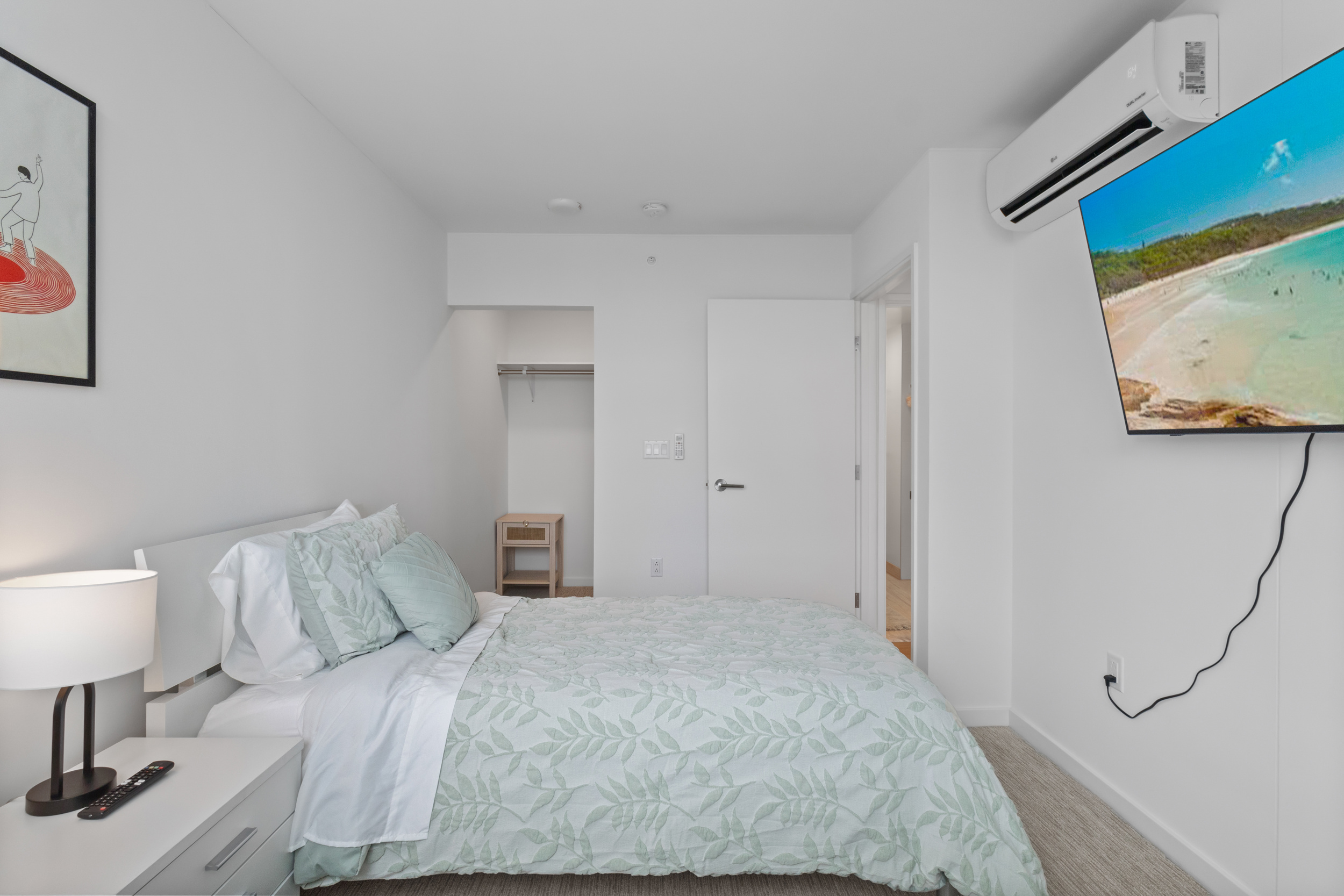 Bright modern bedroom with TV, AC, and cozy minimalist style