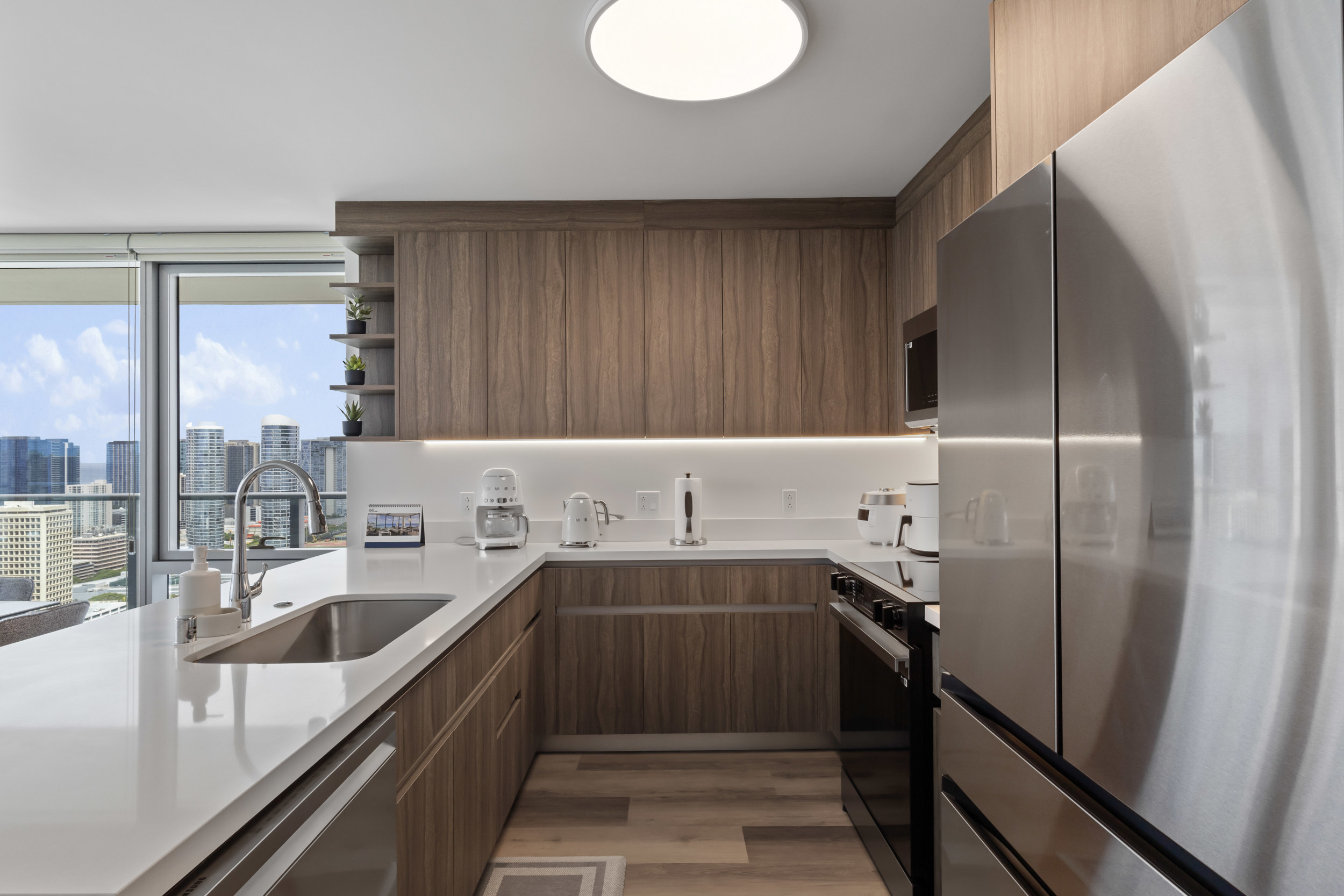 Modern city-view kitchen with quartz counters and stainless appliances