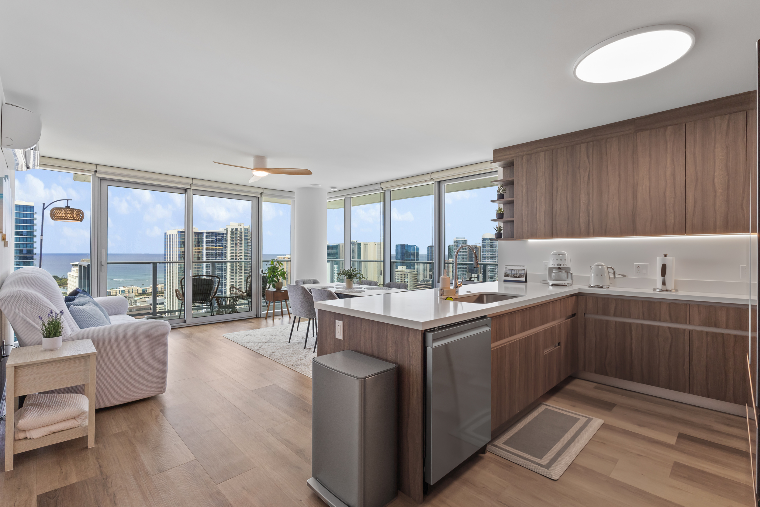 Bright corner condo with modern kitchen, balcony, and stunning city views