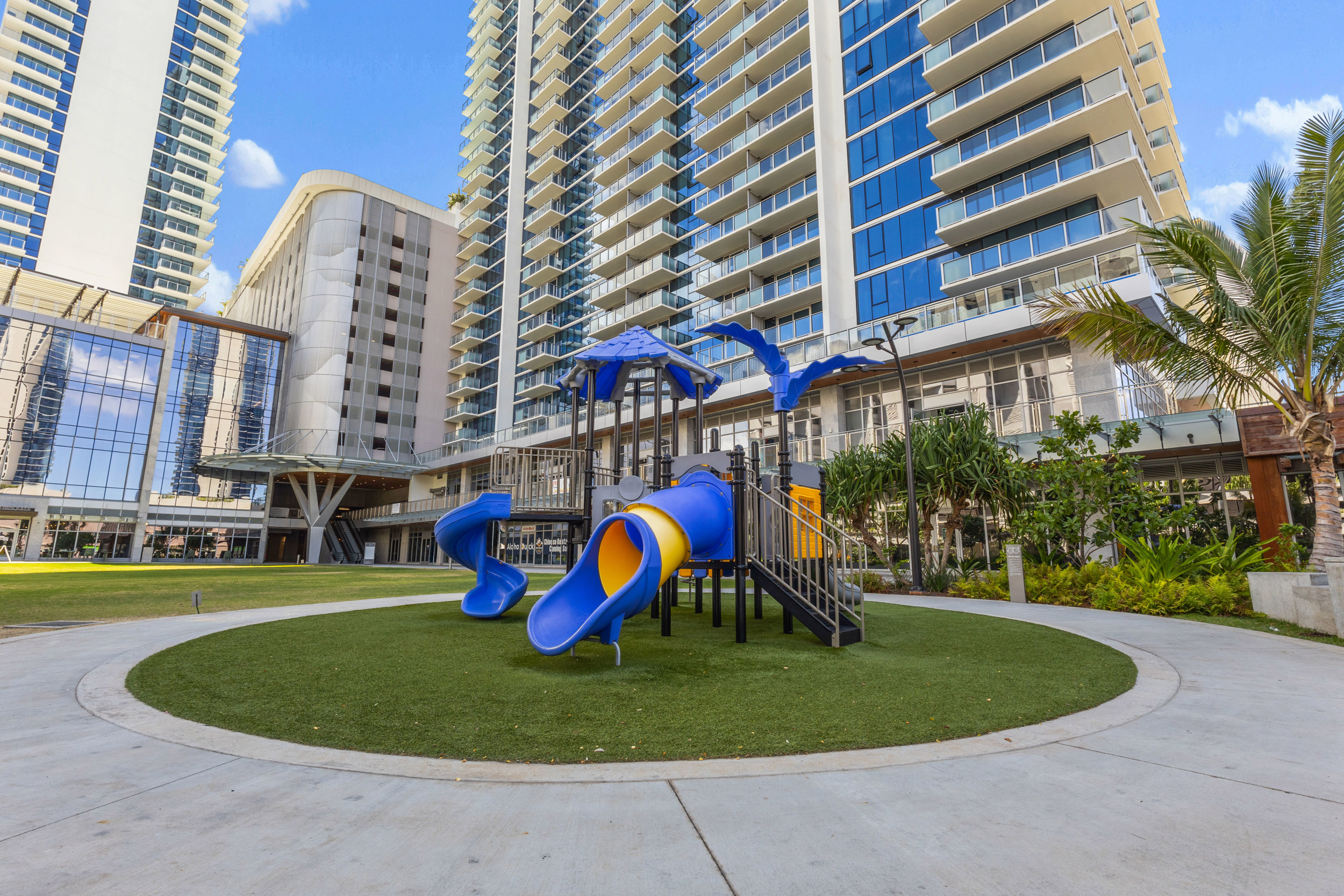 Family-friendly courtyard with modern playground and resort-style setting
