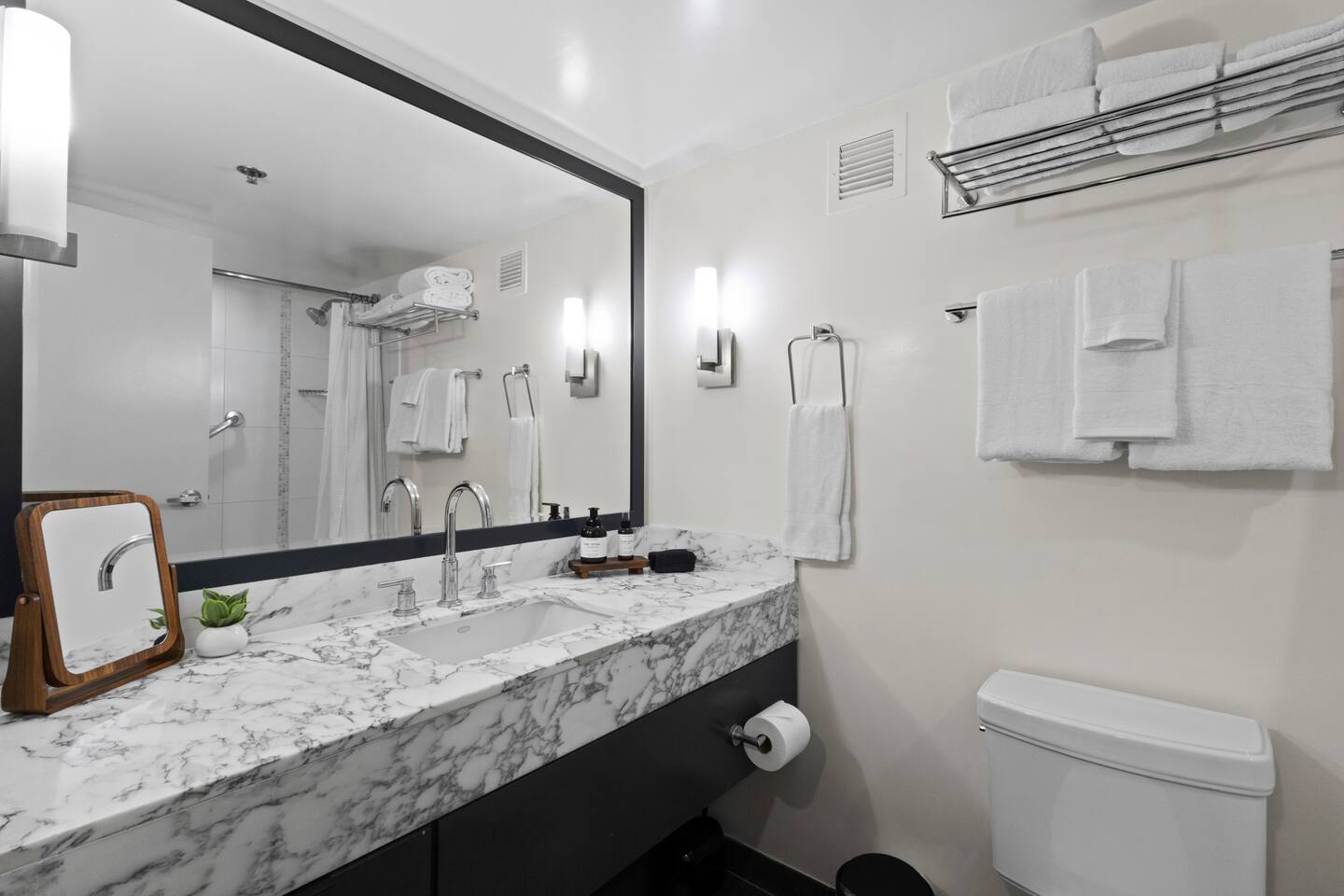 Spacious granite vanity brings a touch of luxury to your daily routine.