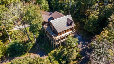 Rested Traveler is a stunning log cabin retreat nestled deep in the trees, featuring wraparound decks that put you right in the heart of the mountain and make you feel beautifully removed from the world.