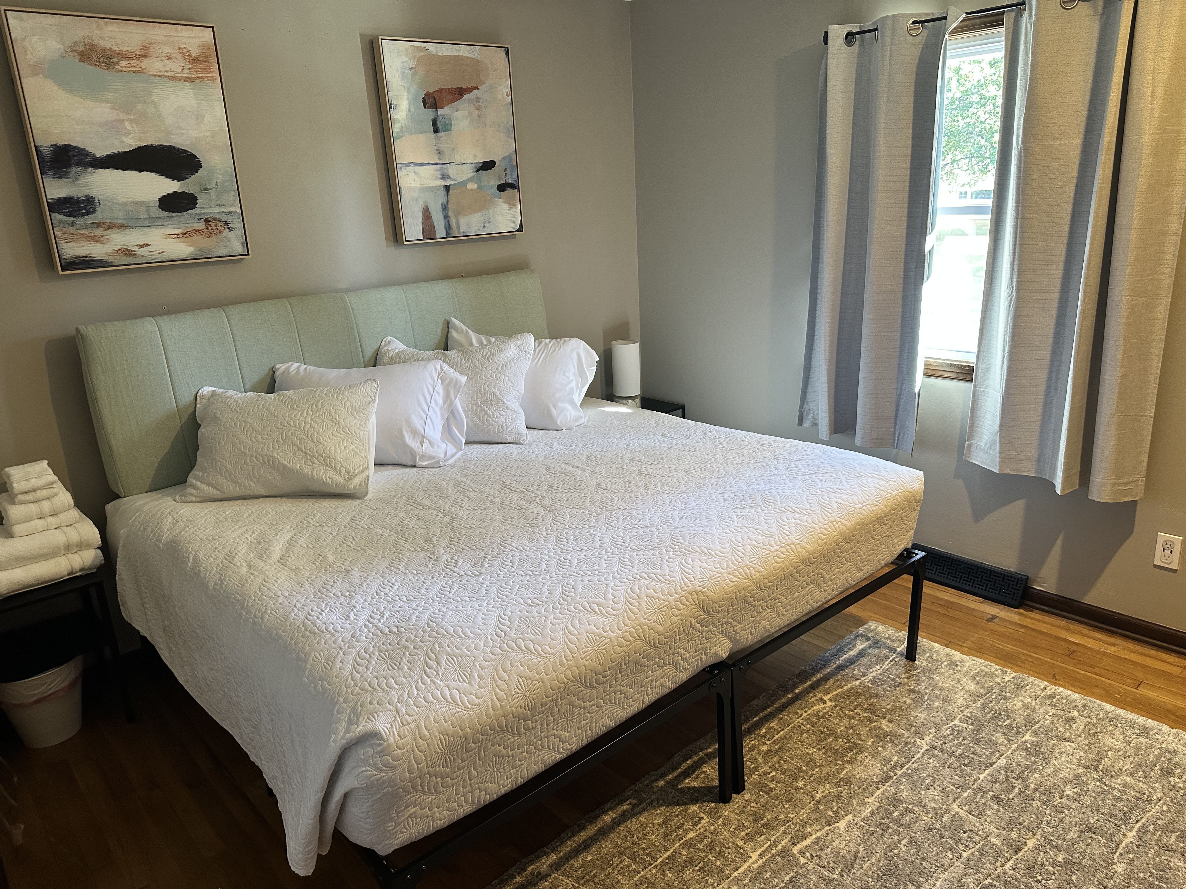 Bright, modern bedroom with plush king bed and natural light