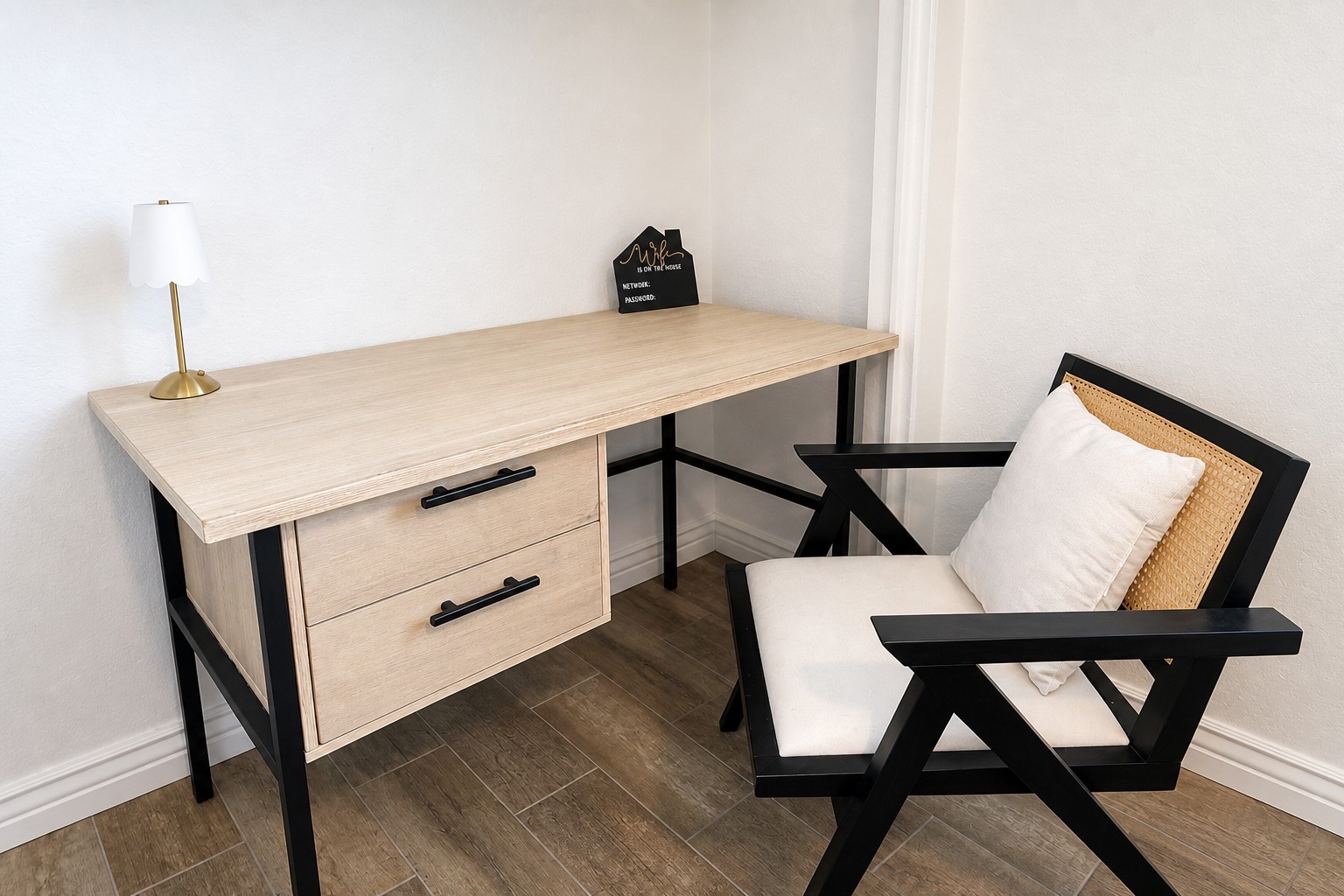 Bright minimalist workspace with desk, drawers, and stylish accent chair