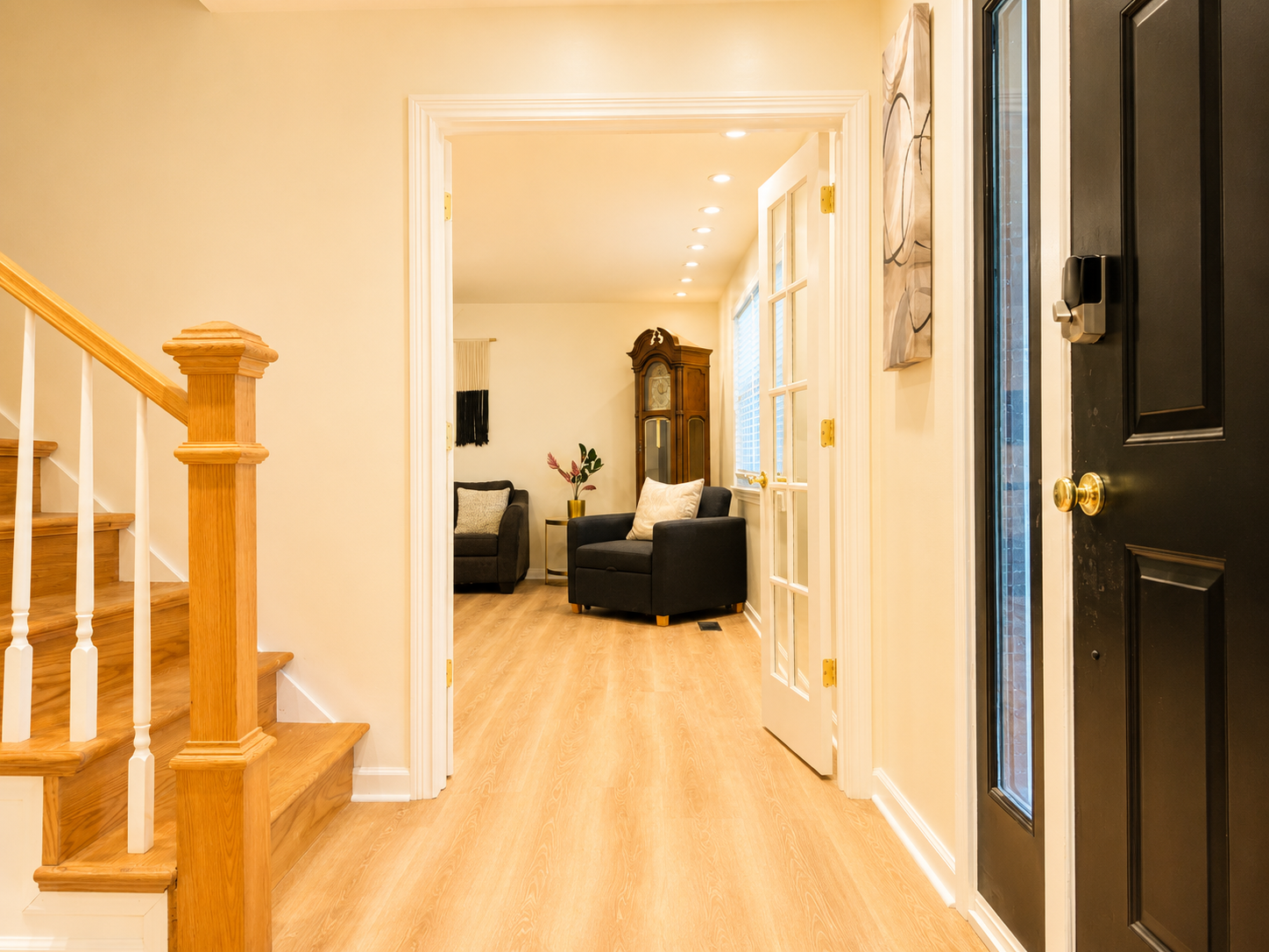 Bright, welcoming entry with cozy sitting area and warm wood finishes