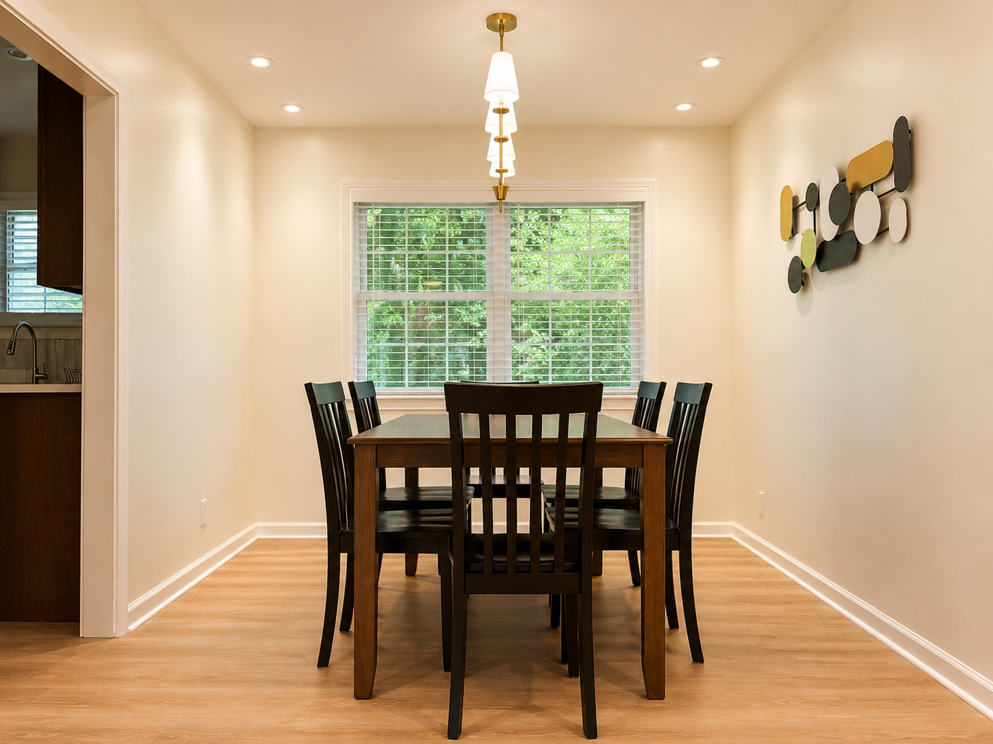 Bright dining room with seating for 6 and tranquil wooded views