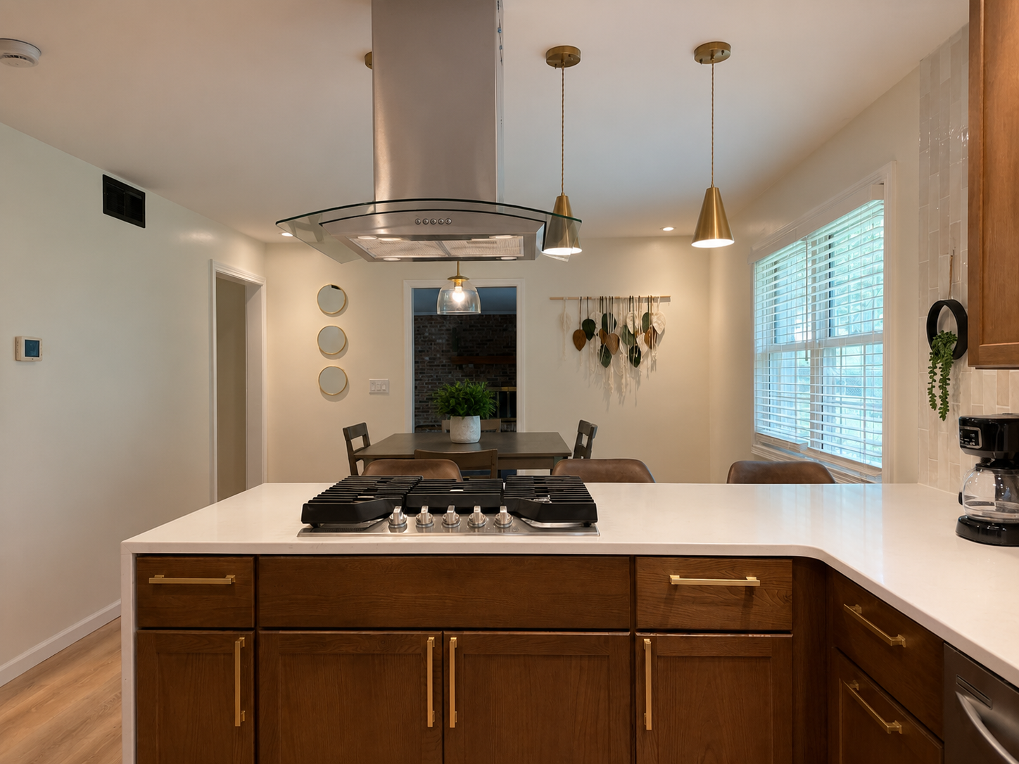 Bright modern kitchen with large island, gas cooktop, and dining space